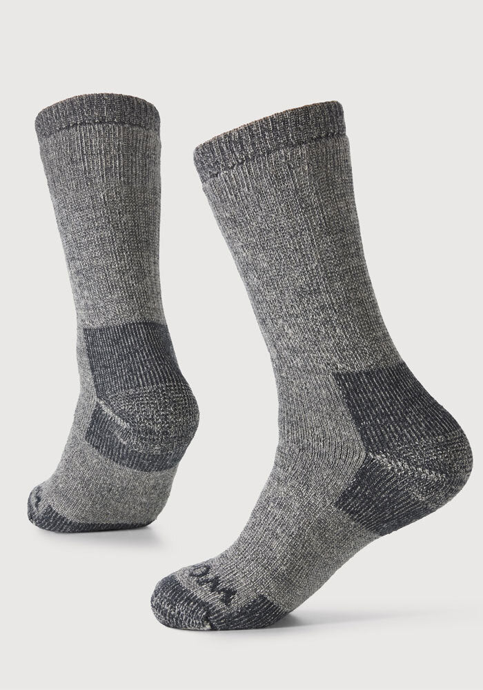 The Woolx Extreme Full Cushion Crew Socks in Charcoal Heather feature thick Merino wool with darker accents on the heel, toe, and sole for superior warmth and comfort, shown against a plain white background.