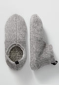 A pair of Woolx Mens Gripper Slippers in Gentle Grey; one is shown top-down to display the opening, while the other is on its side highlighting the ribbed ankle cuff and textured knit fabric.
