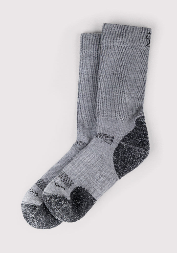 The Woolx Mens Harbor Crew Sock in grey features breathable fabric and darker gray reinforced heels and toes, shown side by side on a light background.