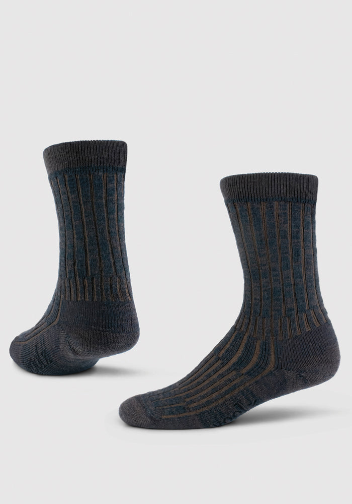 Two Woolx Mens Joey Crew Socks in Dark Espresso are shown on a light background, one upright and one angled to display the ribbed design, side, and sole. These cozy crew socks offer both comfort and style.