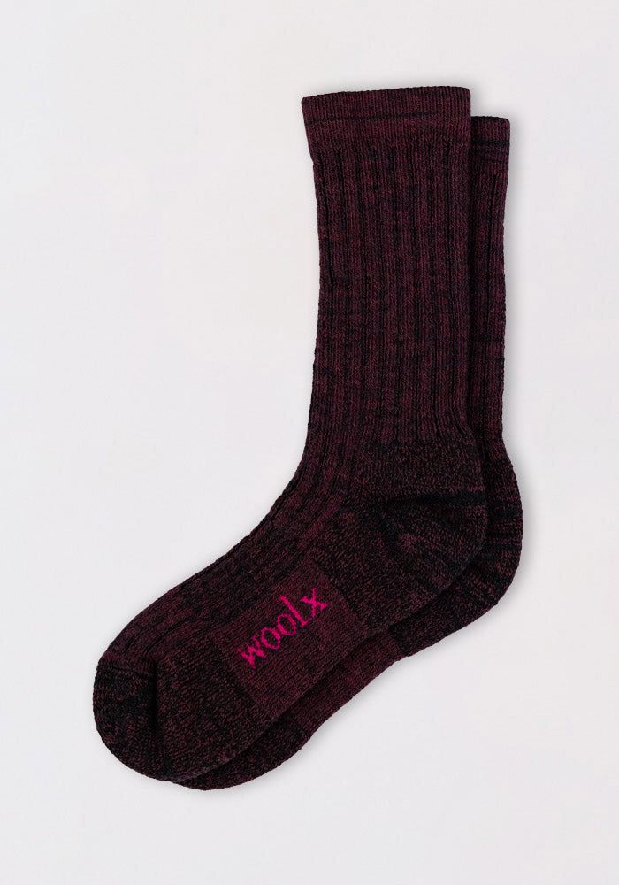 The Mens Joey Crew Socks in Warm Violet by Woolx are ribbed and cozy, made from soft merino wool with "woolx" embroidered in pink on the sole. Displayed on a plain white background.
