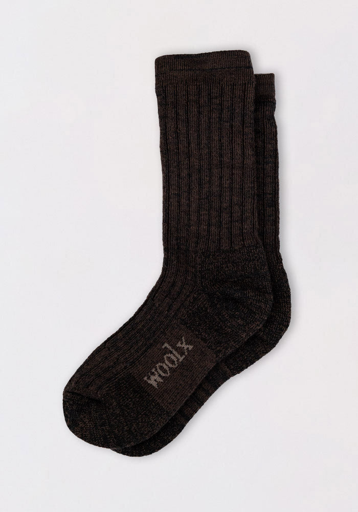 A pair of Woolx Mens Joey Crew Socks in Dark Espresso, featuring ribbed merino wool and "wool" on the sole, lies flat on a white background with one cozy crew sock slightly overlapping the other.