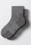 The Woolx Mens Rambler Ankle Sock - Pebble features ribbed cuffs, textured knit, and subtle black sole lettering. Shown overlapping on a light background—ideal moisture-wicking socks for all-day comfort.