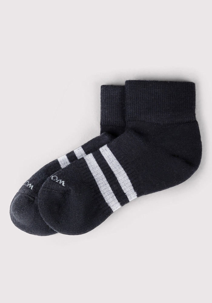 The Woolx Mens Rambler Ankle Sock in black features two white stripes near the cuff. Laid flat on a light background, these Merino wool socks are moisture-wicking for comfort and style. Final Sale.