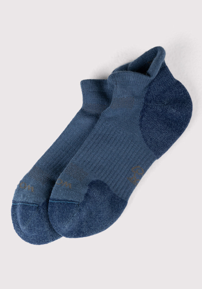 The Woolx Mens Rowan No Show Socks in Majolica Blue feature a short, ankle-length Merino wool design with slightly darker heel and toe, shown on a light gray background.