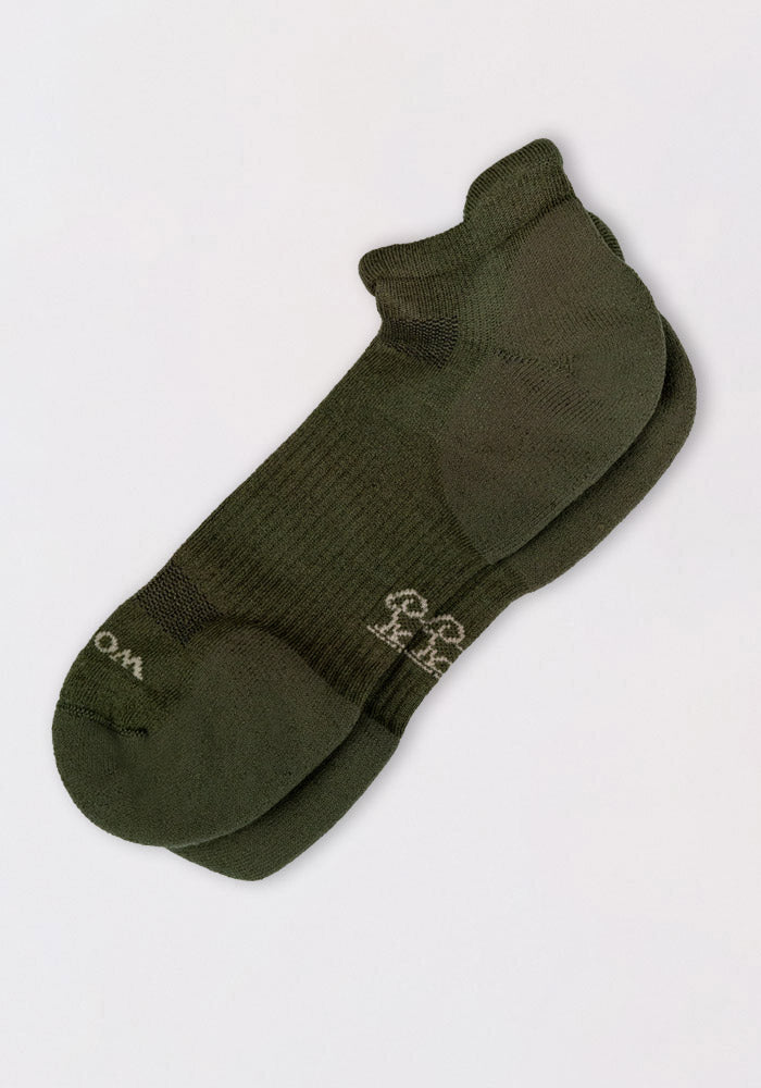 The Woolx Mens Rowan No Show Socks in Winter Moss are cushioned ankle socks with a ribbed texture, a small white logo and text near the toes, shown on a plain white background.