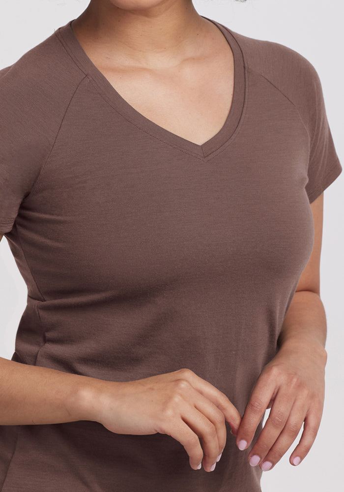 A woman wearing the Woolx Mia V Neck in Peppercorn with her hands gently clasped in front of her.