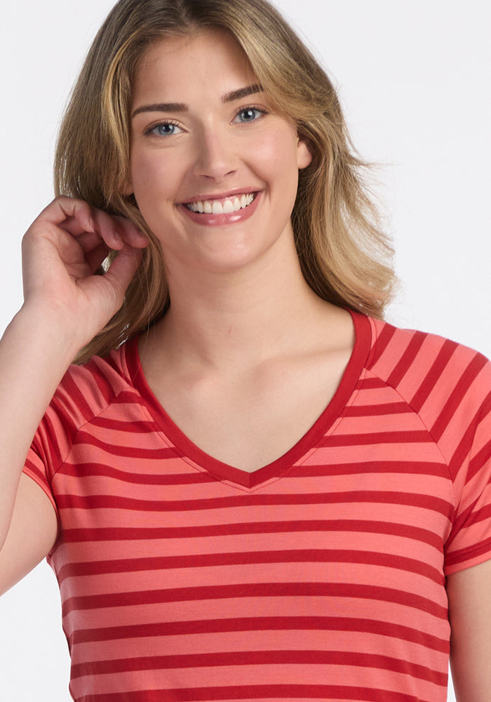 Smiling person with shoulder-length blonde hair in a Woolx Mia V Neck - Wildberry Stripe women's shirt.