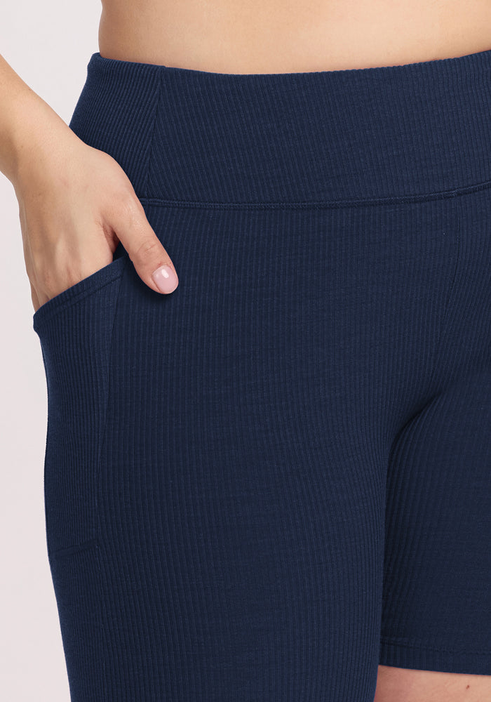 Someone wearing Woolx Miley Bike Shorts • Final Sale - Deep Navy, with one hand in a side pocket.