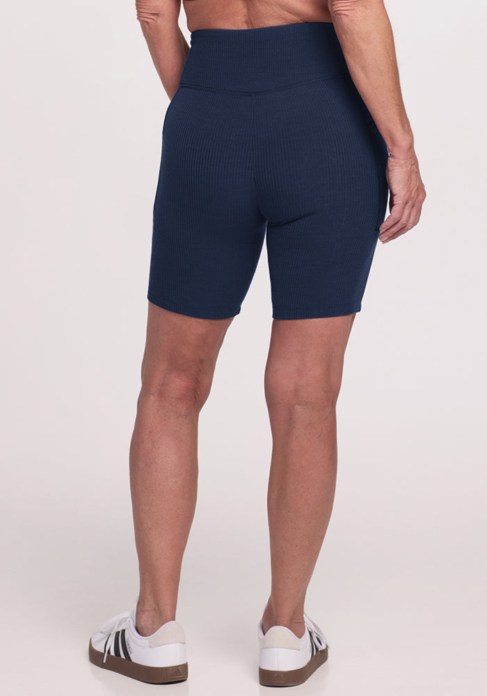 Person wearing Woolx Miley Bike Shorts • Final Sale - Deep Navy with pockets, shown from the back against a plain background.