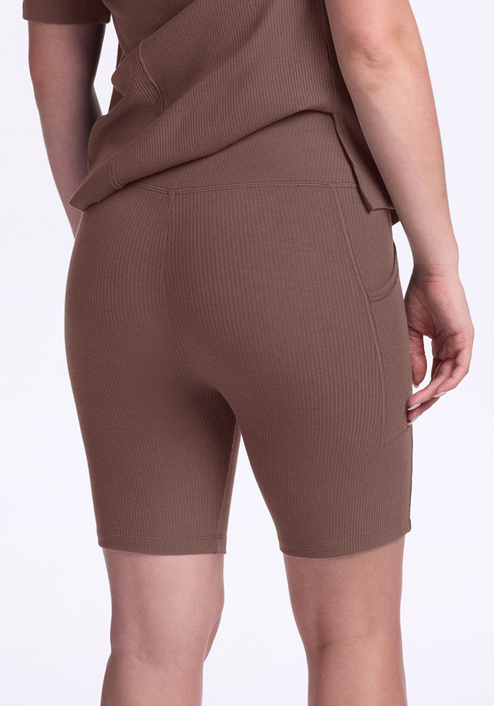 Person in Woolx Miley Bike Shorts - Peppercorn, shown from the back with one arm relaxed at their side.