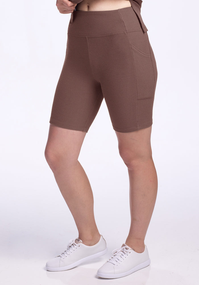 Person wearing Woolx Miley Bike Shorts in Peppercorn and white sneakers, standing against a plain white background. | Ariana is 5'11", wearing a size S