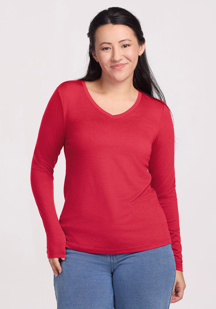 Woman with long dark hair wears the Woolx Millie Long Sleeve in Berry Ice Pop and blue jeans, smiling at the camera. | Sarah is 5'8", wearing a size S