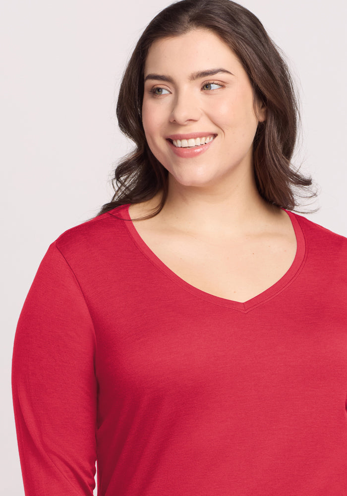 A woman with long brown hair in a Woolx Millie Long Sleeve - Berry Ice Pop smiles, looking left against a light background.