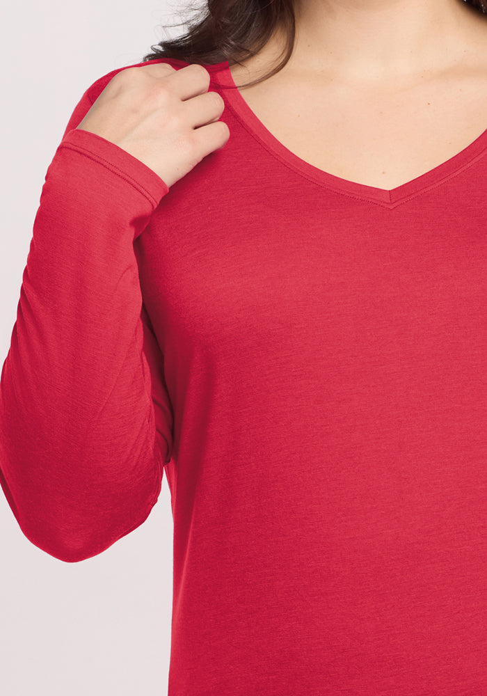 Woman in a Woolx Millie Long Sleeve - Berry Ice Pop, her left hand gently touching her collar.