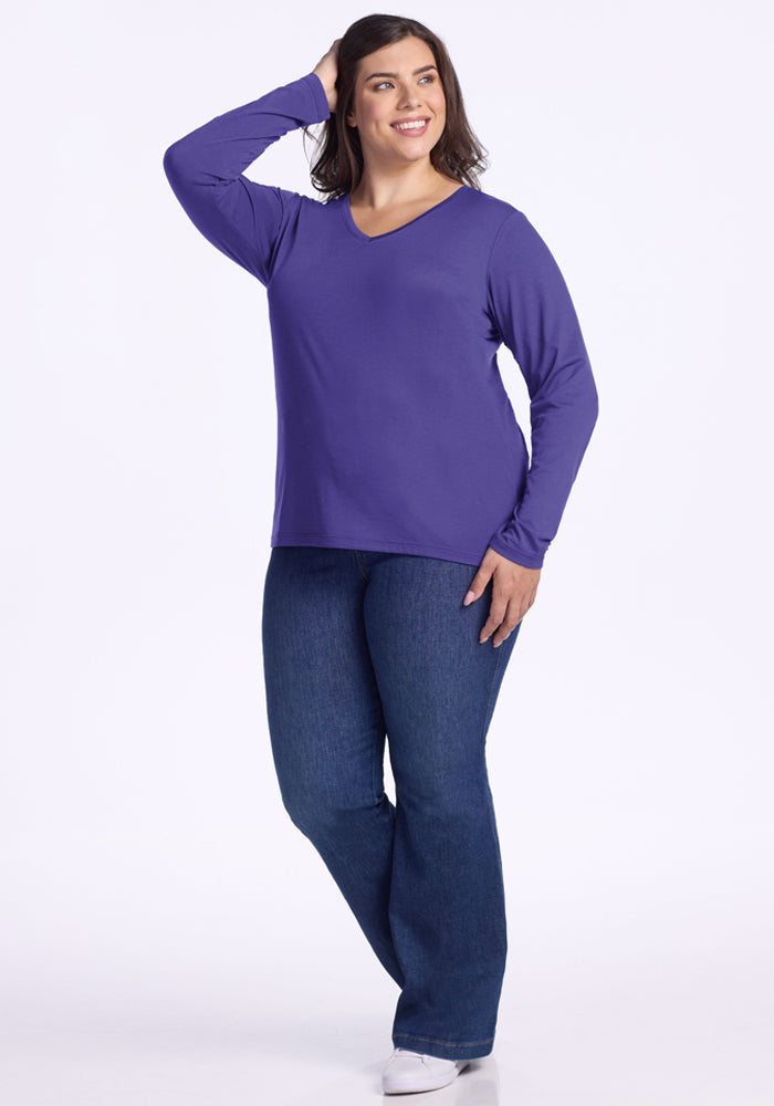 Woman smiling in the Woolx Millie Long Sleeve - Berry Indigo, paired with blue jeans, hand in her hair.