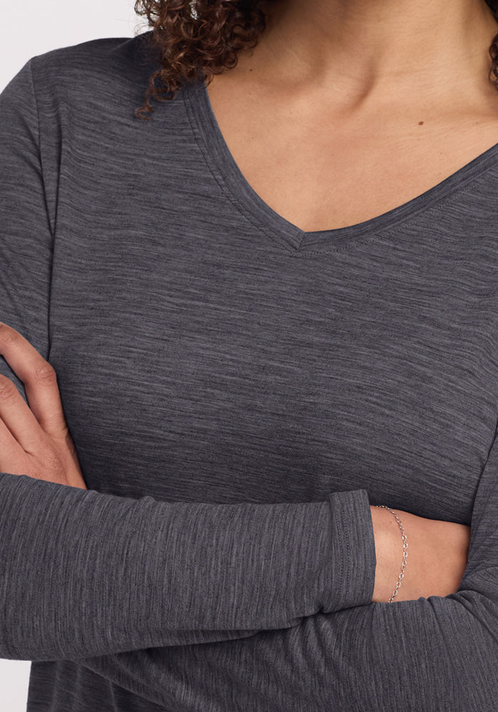 Person wearing Woolx Millie Long Sleeve in Cinder Melange, arms crossed, with a delicate chain bracelet.