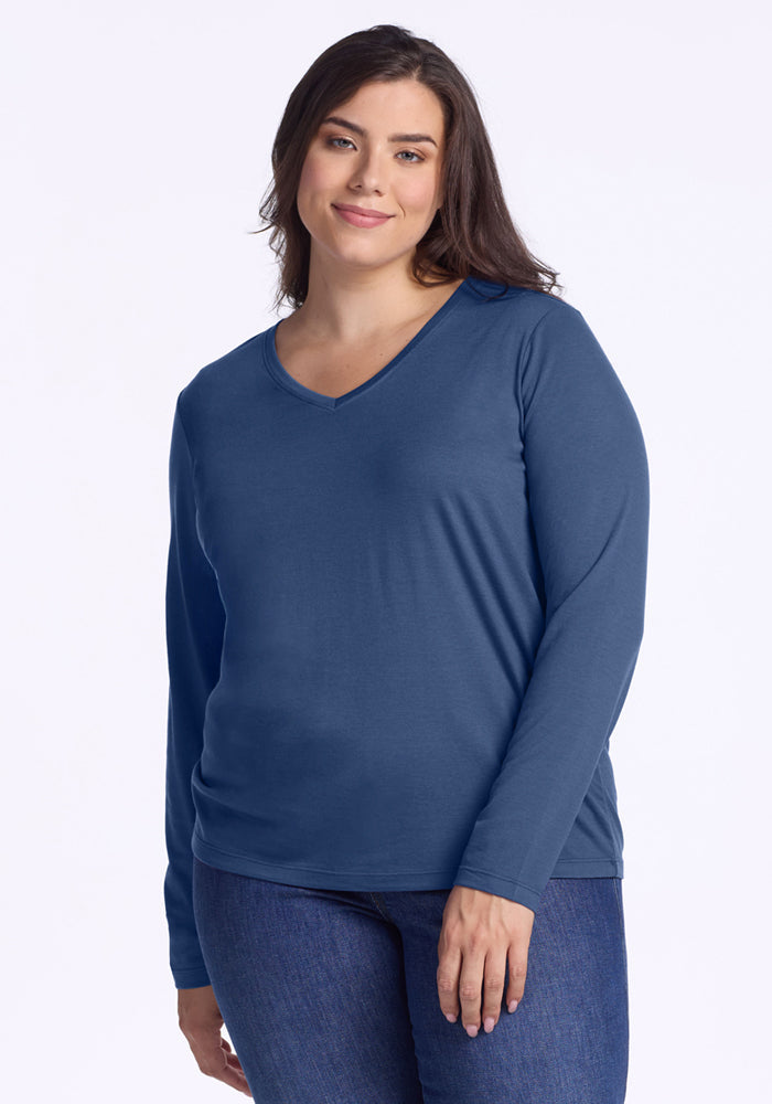 Woman in Woolx Millie Long Sleeve • Final Sale - Starry Night top and jeans, smiling against a light background.