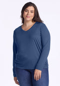 Woman in Woolx Millie Long Sleeve • Final Sale - Starry Night top and jeans, smiling against a light background.