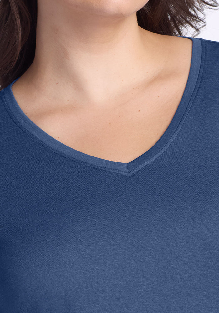 A person in a blue Woolx Millie Long Sleeve top, Starry Night color, shown from shoulders to upper chest.