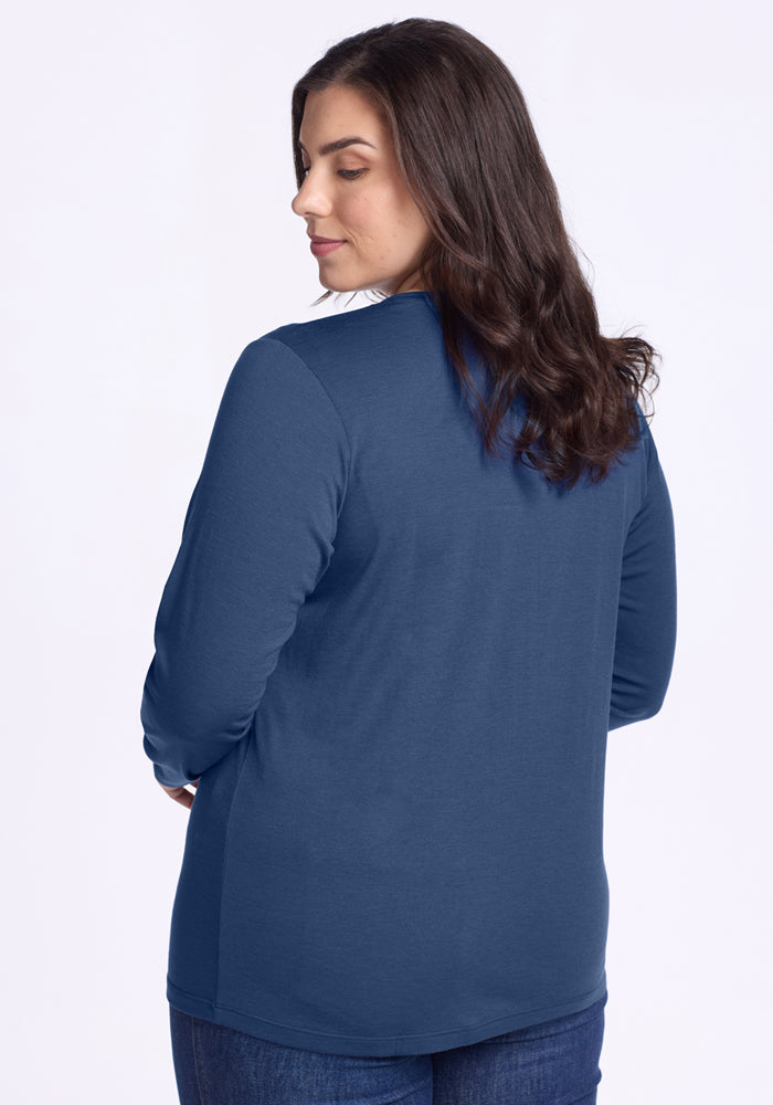 Woman with long brown hair wears the Woolx Millie Long Sleeve in Starry Night and dark jeans, against a light background.