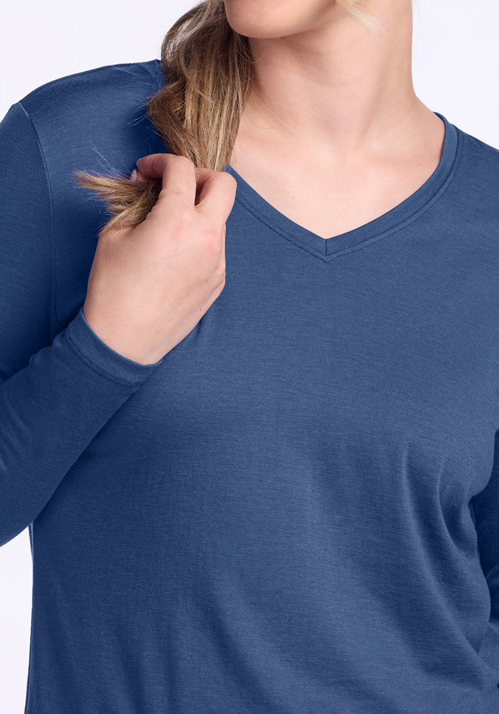Person in a Woolx Millie Long Sleeve • Final Sale - Starry Night, holding blonde hair near their shoulder.