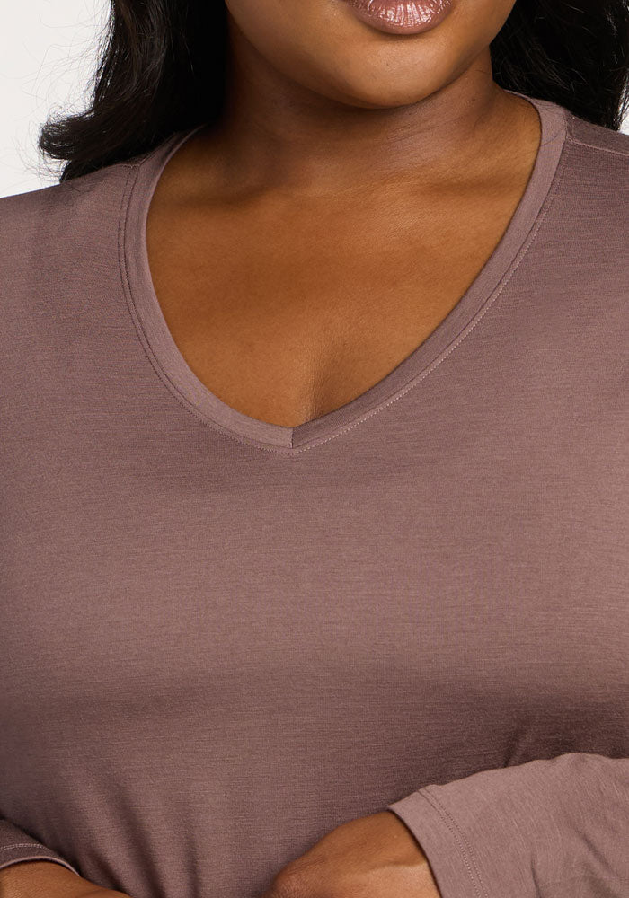 A woman wearing the Woolx Millie Long Sleeve in Peppercorn, shown from shoulders to just above chest and lips.