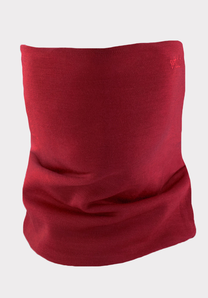 The Woolx Neck Gaiter • Final Sale - Rhubarb is shown upright against a light gray background. Its soft, stretchy Merino wool with subtle folds and texture makes it ideal as an outdoor neck warmer.