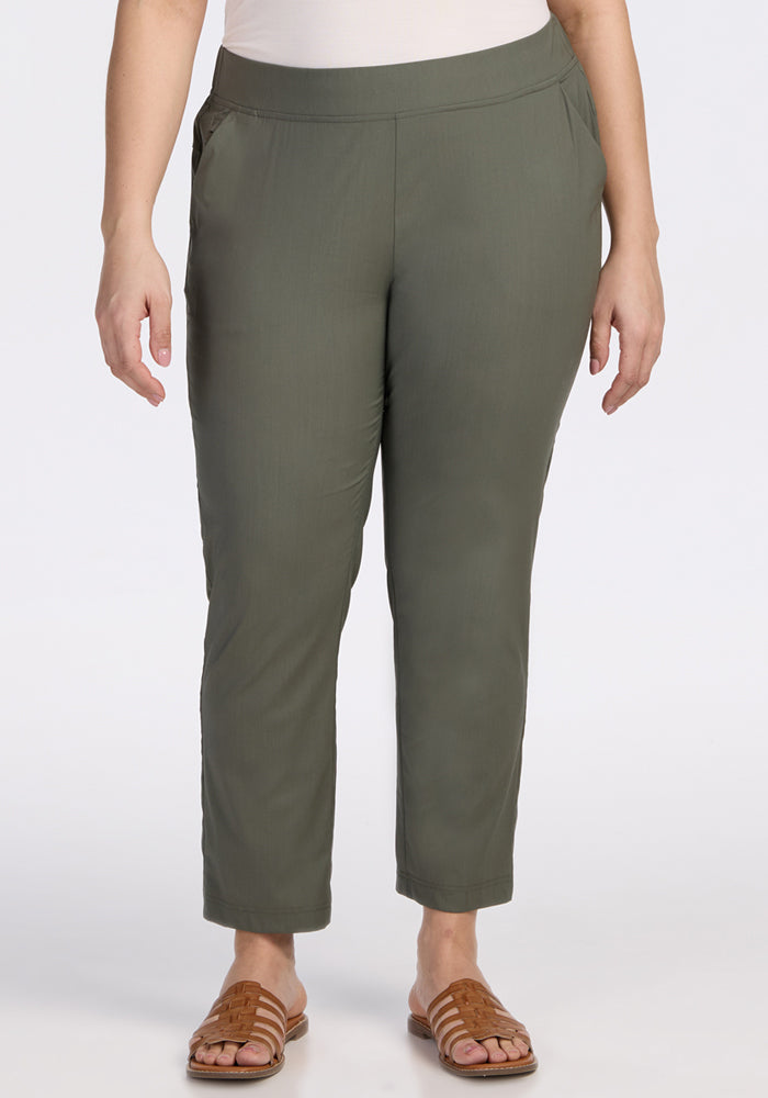 A person stands against a plain white background wearing Woolx Nicole Ankle Pants in Sage Olive and brown sandals, hands relaxed at their sides. | Juliana is 5'10", wearing a size XL