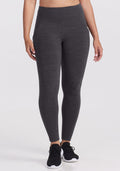 A person wearing Woolx Piper Pocket Leggings in Cinder Melange and black athletic shoes stands against a plain white background, shown from midriff to feet. | Tori is 5'7", wearing a size S