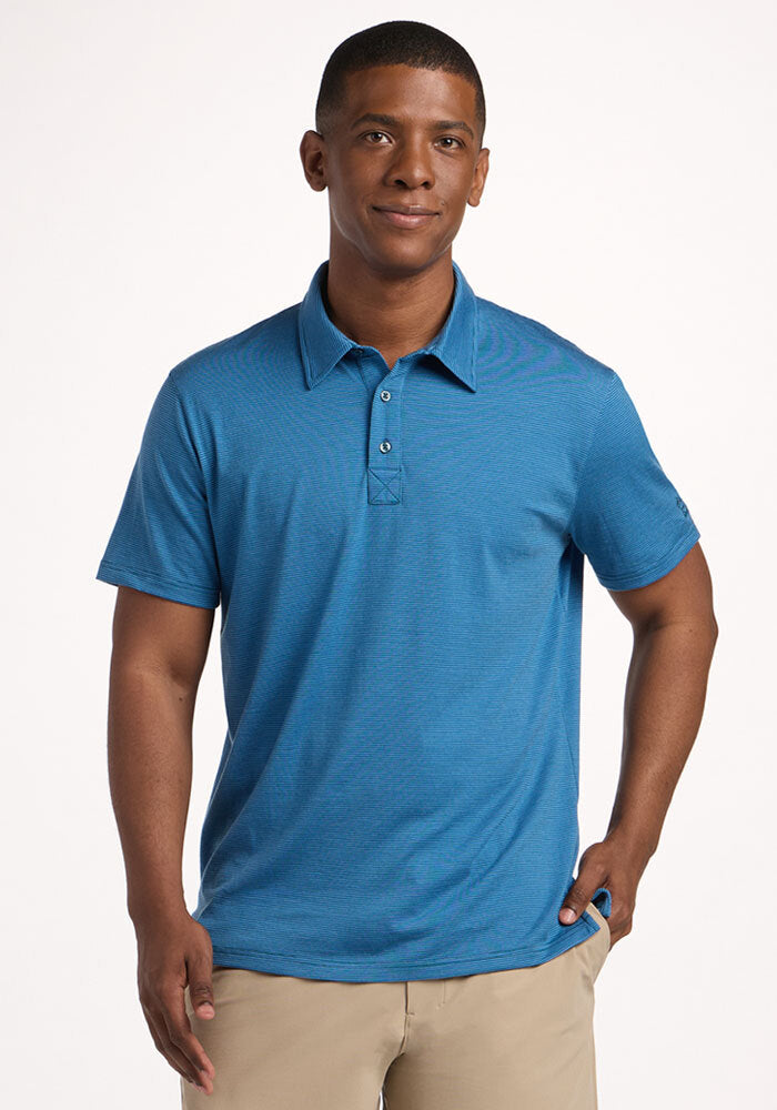 Man wearing the Woolx Preston Polo - Coastal Mini Stripe, smiling with one hand in his pocket. | Trell is 6’2”, wearing a size M