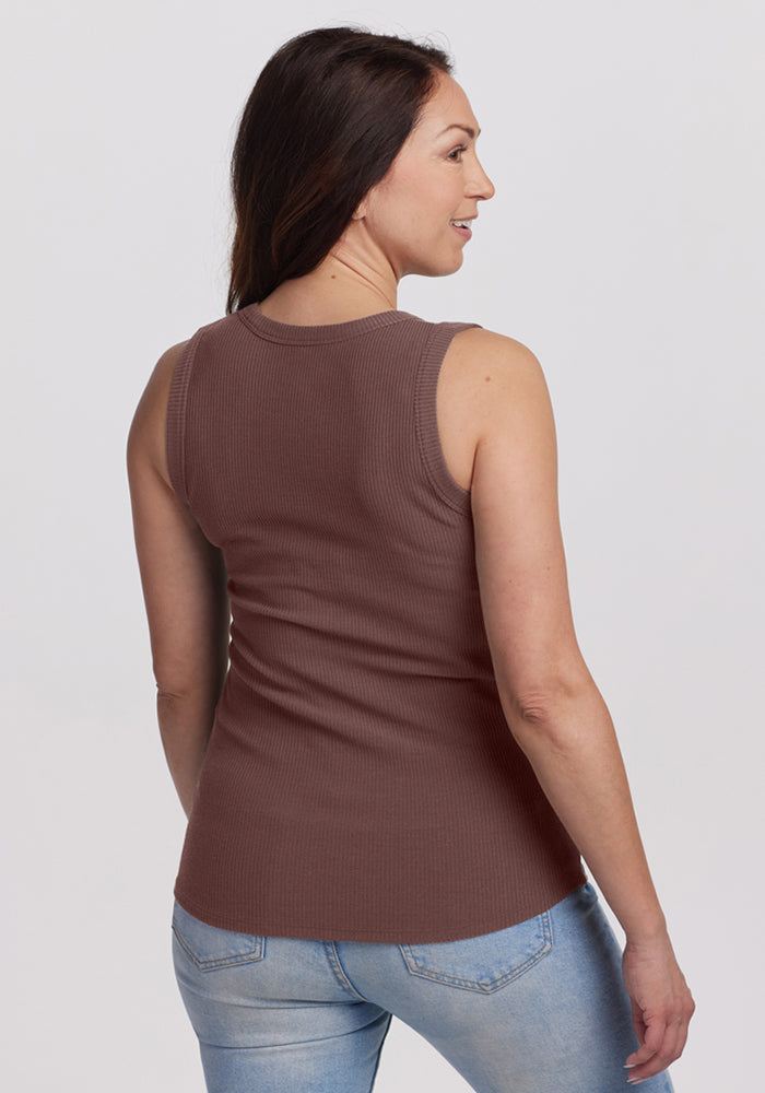 Woman with long brown hair wearing the Woolx Raegan Ribbed Tank Top in Peppercorn and light blue jeans, smiling.