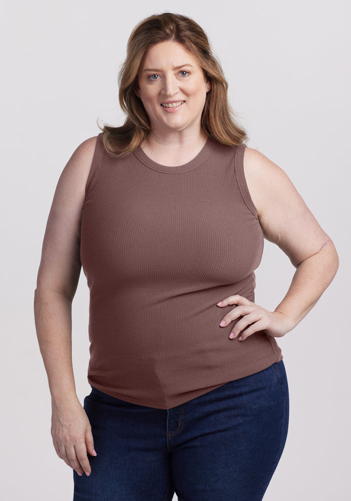 Smiling woman wears the Woolx Raegan Ribbed Tank Top in Peppercorn and dark jeans against a plain background. | Cambre is 5'11", wearing a size XL