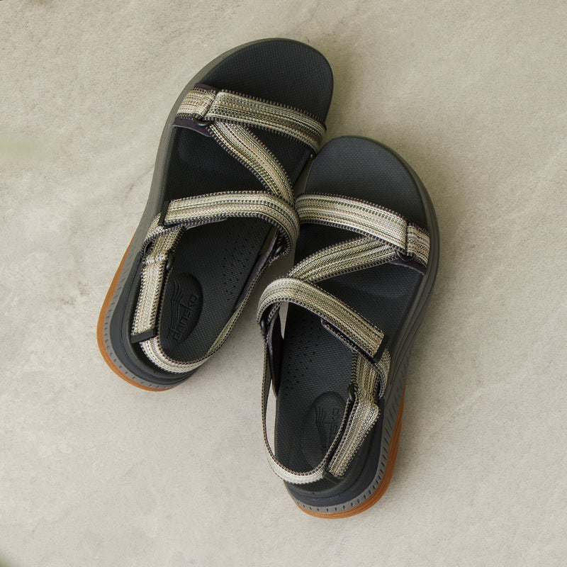 A detailed footbed and strap image of green and black walking sandals.