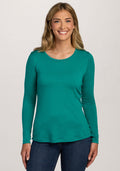 Smiling woman with long blonde hair wears the Woolx Remi Long Sleeve T-Shirt in Cabana Crush, with jeans. | Ariana is 5'11", wearing a size S