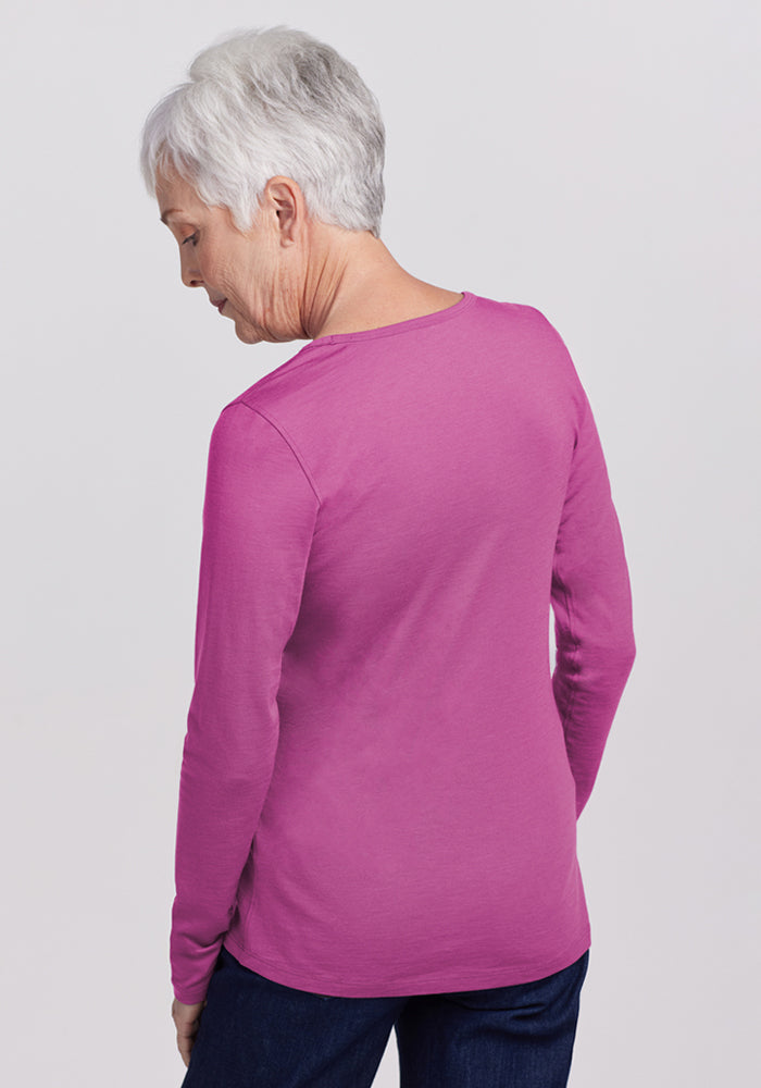 Older woman with short gray hair in a Woolx Remi Long Sleeve T-Shirt in Purple Wine, facing away from the camera.