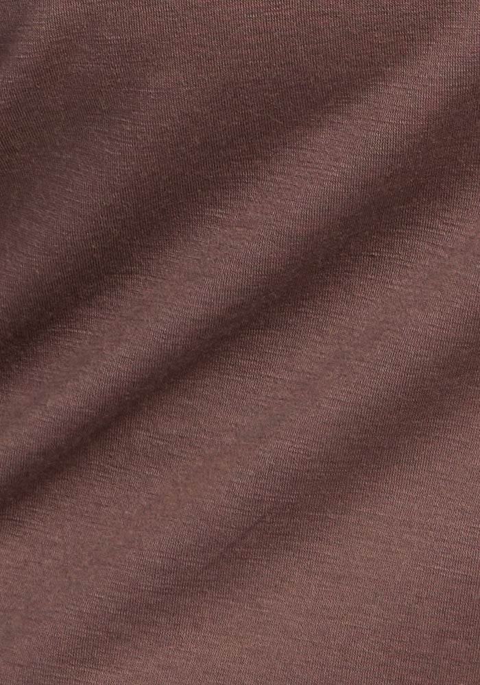 A close-up of Woolx Remi Long Sleeve T-Shirt in Peppercorn shows its soft, smooth Merino wool fabric.