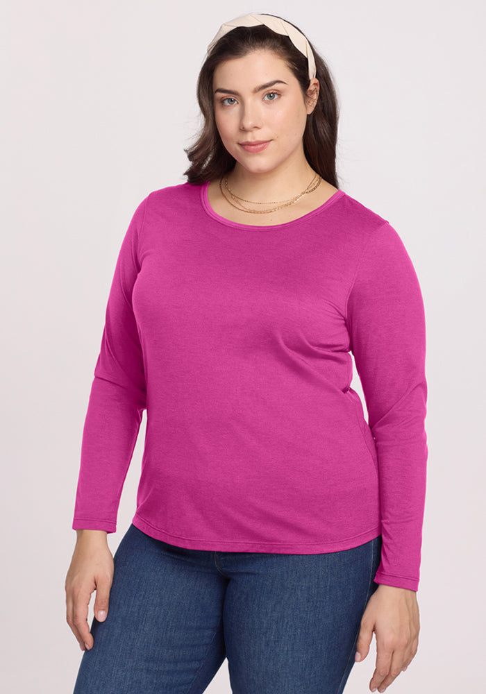 Woman wears the Woolx Remi Long Sleeve T-Shirt in Summer Sorbet with blue jeans against a plain light background. | Juliana is 5'10", wearing a size XL