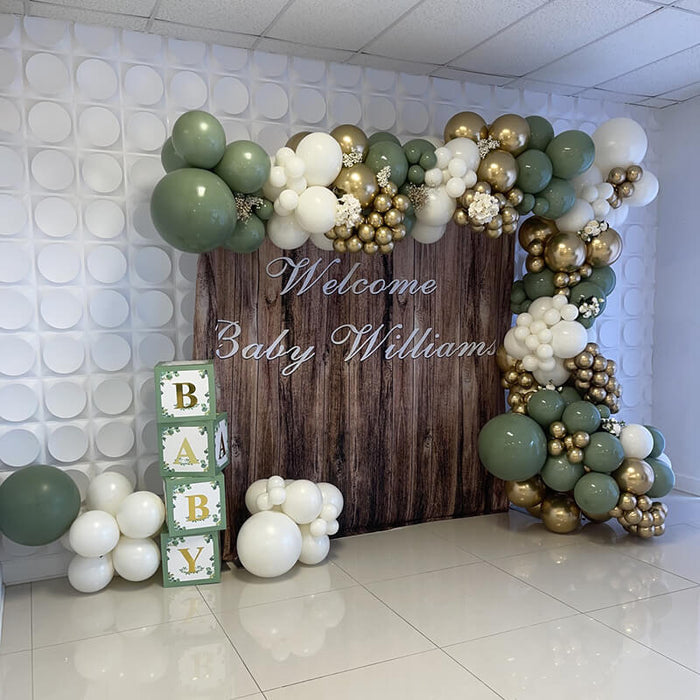 Wood wedding backdrop used for baby shower with sage green, white and gold balloon garland