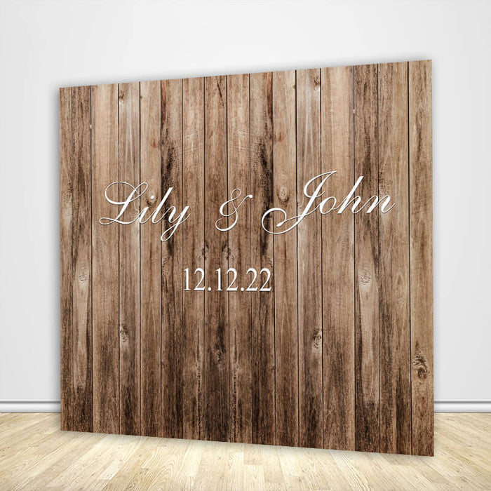 Rustic wood wedding backdrop with custom Lily and John names and wedding date