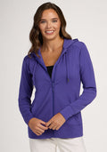 Woman wearing the Woolx Ryann Hoodie in Berry Indigo over a black top, smiling against a light background. | Madeleine is 5’10”, wearing a size XS