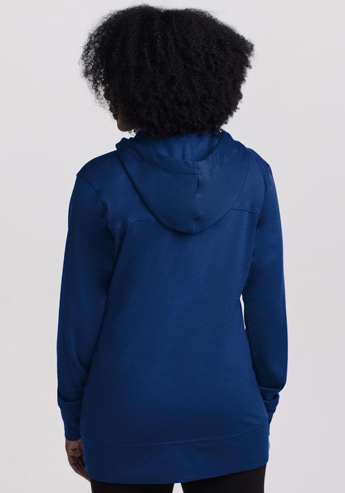Person with curly hair wears the Woolx Ryann Hoodie in Estate Blue, shown from the back on a light background.