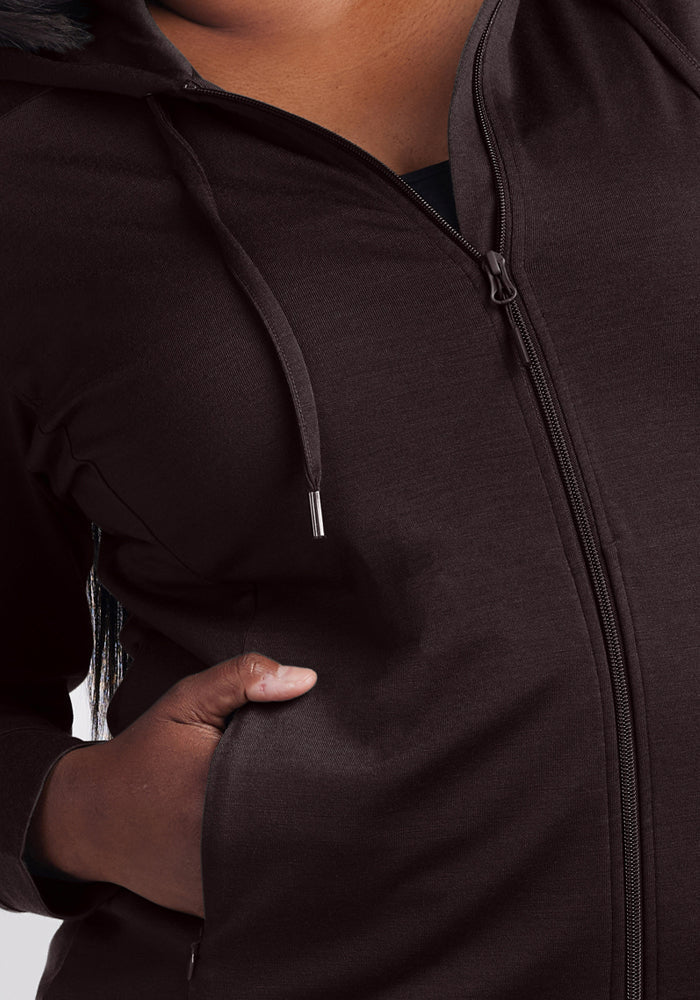 Someone wearing the Woolx Ryann Hoodie in French Roast with one hand in the front pocket.
