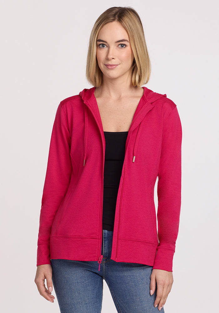 Woman with straight blonde hair wears the Woolx Ryann Hoodie • Final Sale - Poppy Spark, black top, and blue jeans.