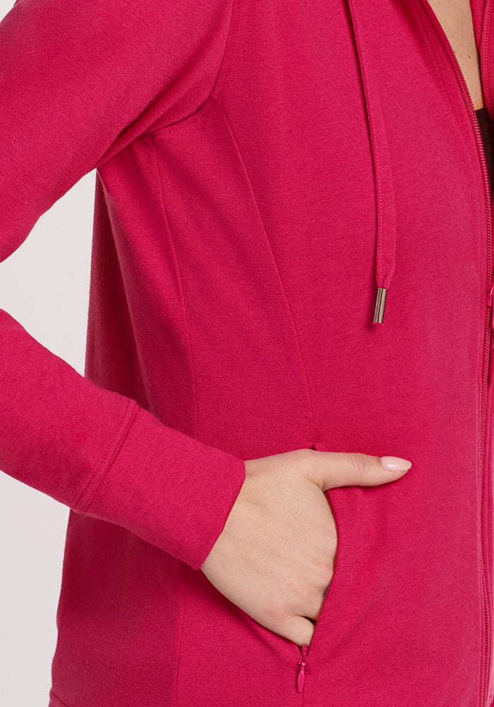 Woman in the Woolx Ryann Hoodie • Final Sale - Poppy Spark, one hand in pocket, cropped at the shoulder.