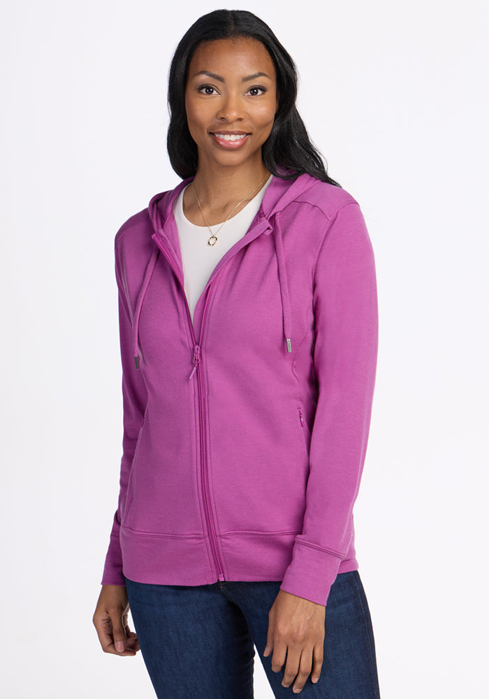 Smiling woman in Woolx Ryann Hoodie • Final Sale - Purple Wine, over a white top, on a plain white background.