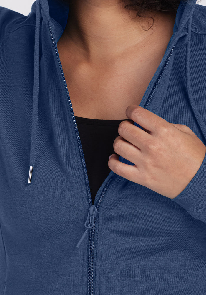 Someone partially unzips the Woolx Ryann Hoodie • Final Sale - Starry Night, revealing a black shirt underneath.