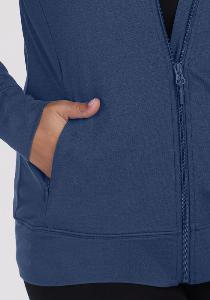 A person wearing the Woolx Ryann Hoodie in Starry Night with a hand in the pocket, shown waist down.