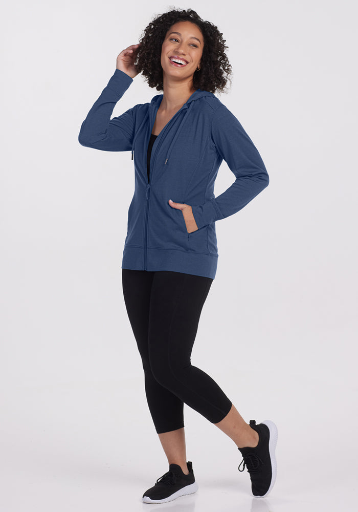 Smiling woman in a Woolx Ryann Hoodie • Final Sale - Starry Night poses against a plain white background.