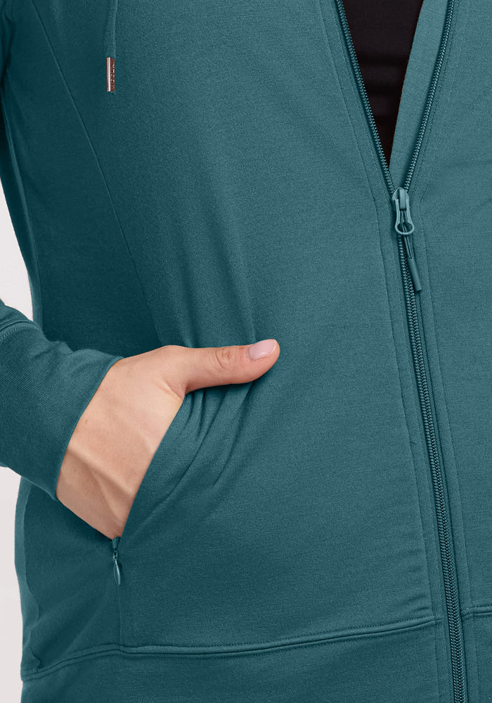 A hand is placed in the pocket of the Woolx Ryann Hoodie • Final Sale - Tidepool.